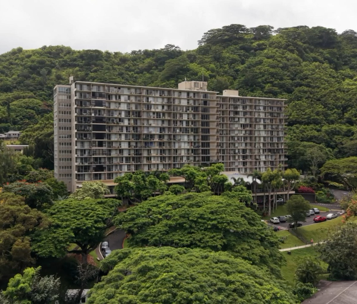 Residential valley community beneath lush green mountains in Hawaiʻi